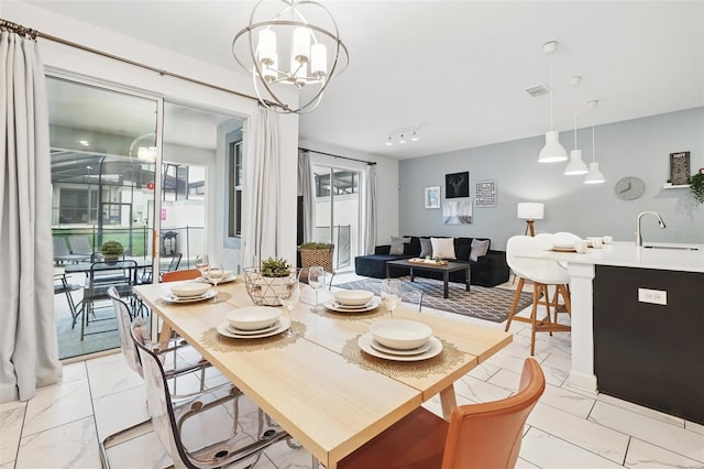 dining room with a notable chandelier and marble finish floor