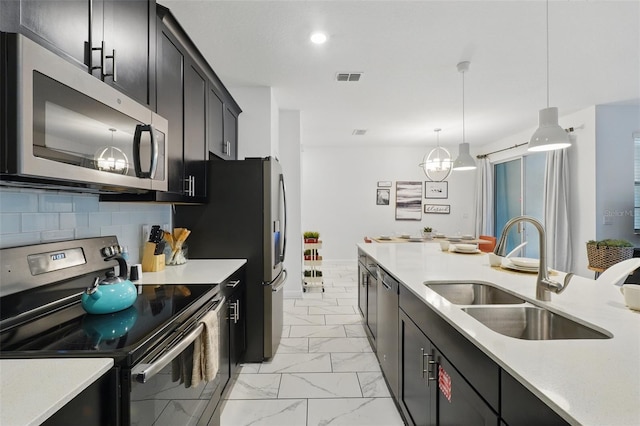 kitchen featuring visible vents, marble finish floor, a sink, stainless steel appliances, and light countertops