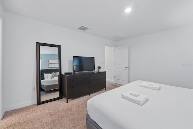 bedroom with recessed lighting, visible vents, light carpet, and baseboards