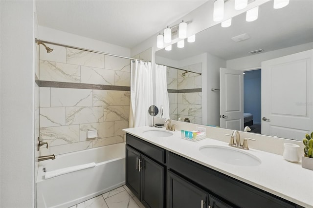 bathroom featuring visible vents, marble finish floor, shower / tub combo with curtain, and a sink