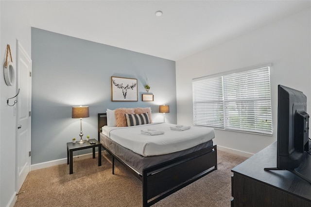 carpeted bedroom featuring baseboards