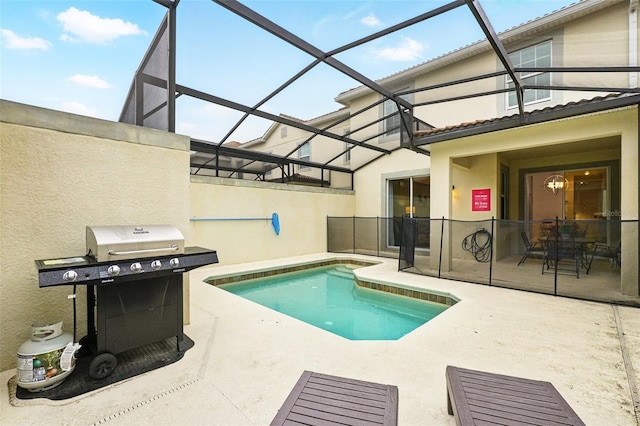 outdoor pool with a lanai, a patio area, and grilling area