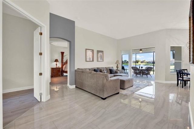 living area featuring arched walkways and baseboards