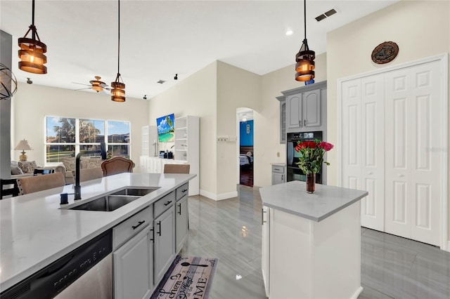 kitchen featuring ceiling fan, dishwasher, light countertops, dobule oven black, and a sink