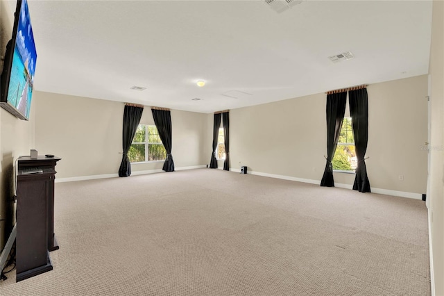 unfurnished room with carpet flooring, baseboards, and visible vents