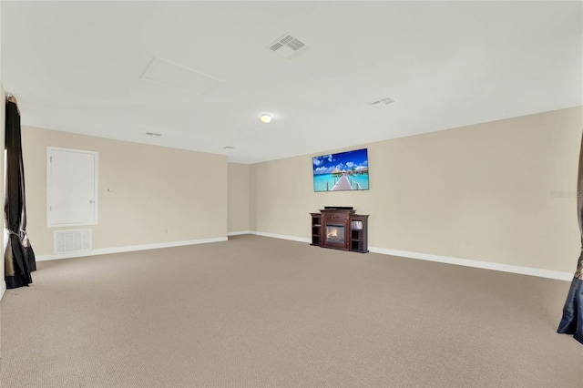 interior space with visible vents, light colored carpet, and baseboards