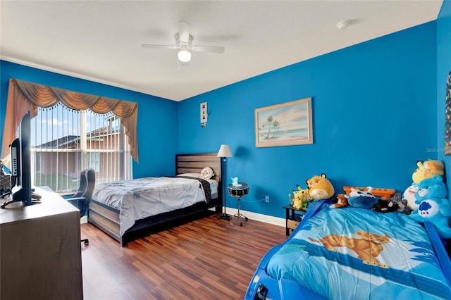 bedroom featuring access to exterior, ceiling fan, baseboards, and wood finished floors