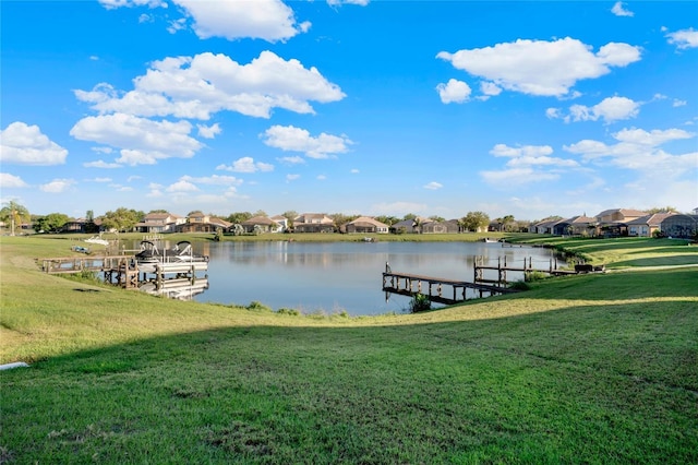 dock area featuring a yard, a residential view, a water view, and boat lift