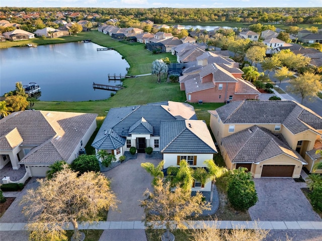 drone / aerial view with a residential view and a water view