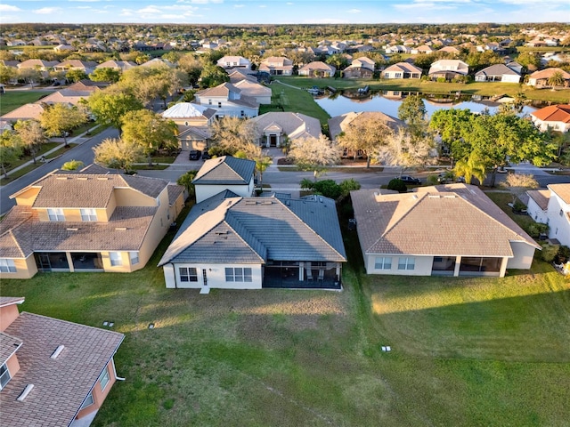 bird's eye view featuring a residential view and a water view