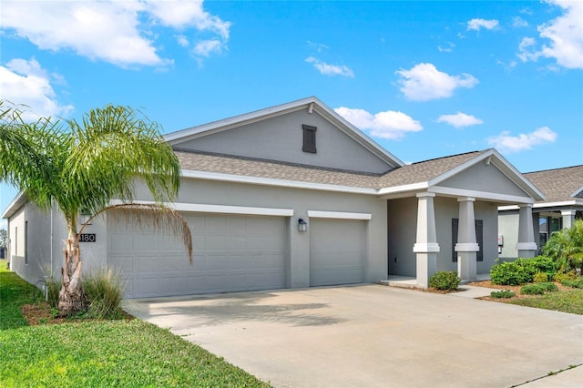 single story home with a garage, a shingled roof, concrete driveway, and stucco siding