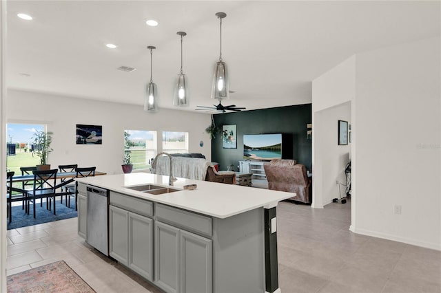 kitchen featuring a sink, dishwasher, a wealth of natural light, and light countertops