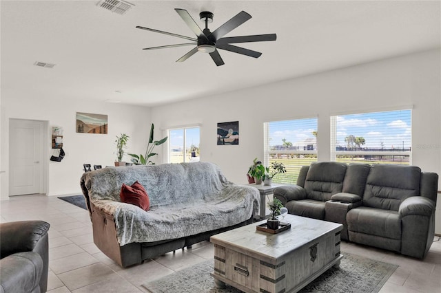 living area with light tile patterned floors, visible vents, and a ceiling fan