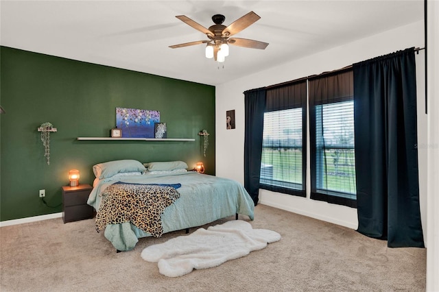 bedroom featuring baseboards, a ceiling fan, and carpet flooring