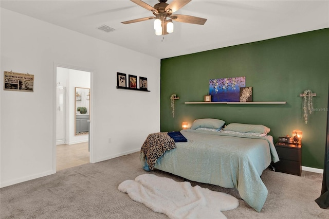 bedroom featuring visible vents, baseboards, carpet, and a ceiling fan