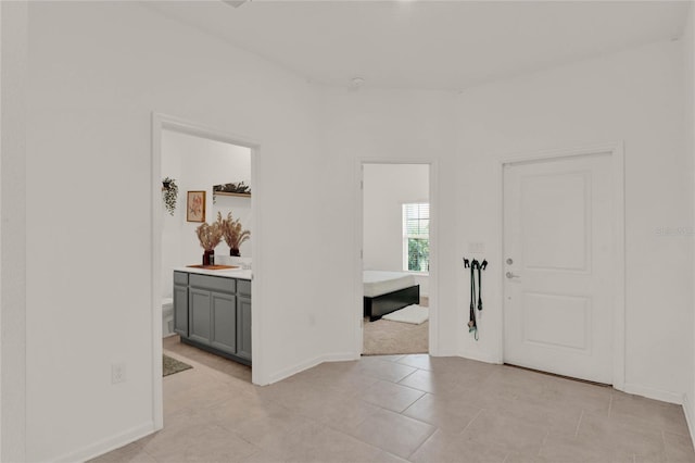 interior space featuring light tile patterned floors and baseboards