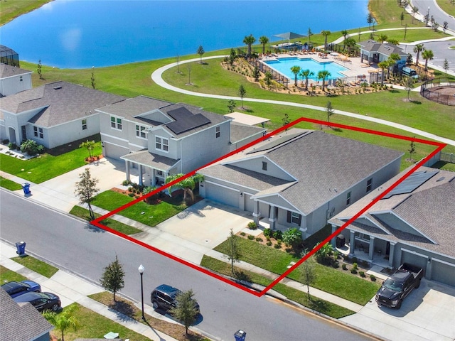 birds eye view of property with a water view and a residential view