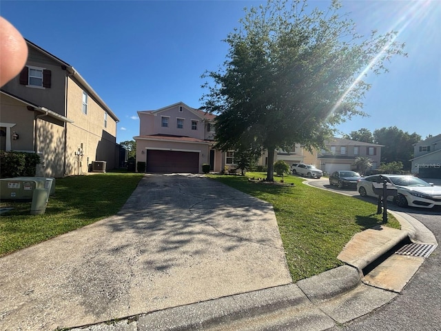 view of front of house featuring a garage, a front yard, stucco siding, and concrete driveway