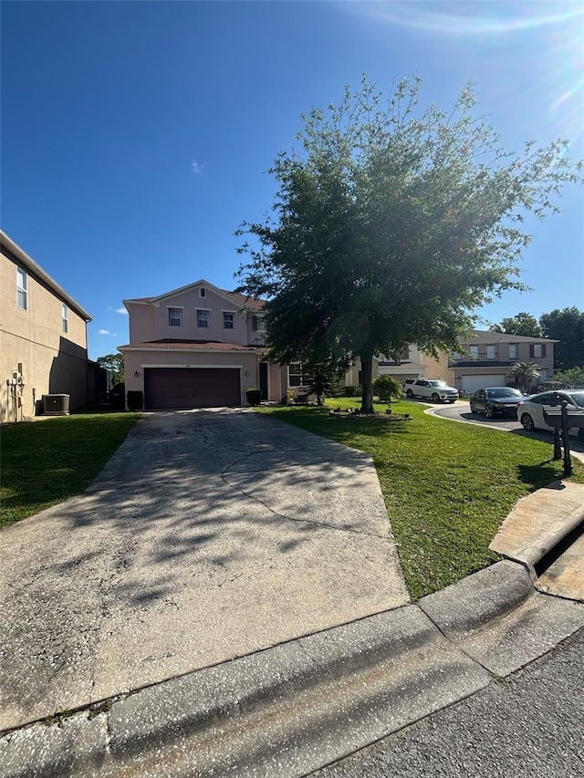 view of front of house featuring a garage, stucco siding, driveway, and a front lawn