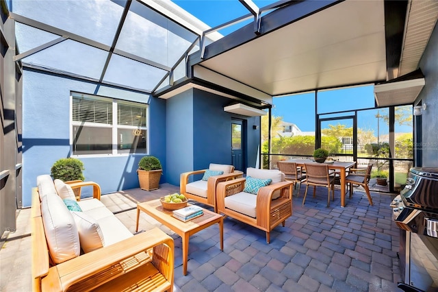 view of patio featuring glass enclosure, an outdoor living space, and outdoor dining space