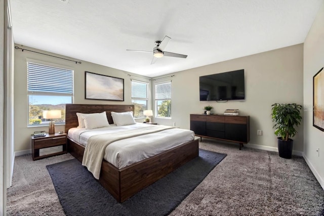 carpeted bedroom featuring ceiling fan and baseboards