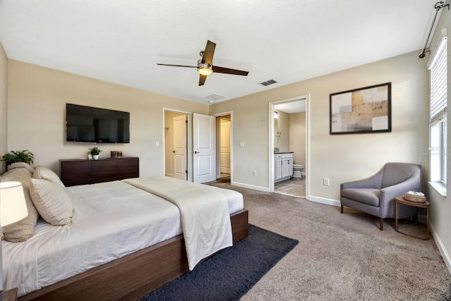 bedroom featuring visible vents, baseboards, ensuite bathroom, and carpet flooring