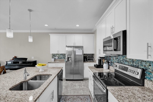 kitchen featuring backsplash, white cabinetry, stainless steel appliances, and a sink