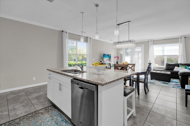 kitchen with a kitchen island with sink, open floor plan, light tile patterned floors, stainless steel dishwasher, and a sink