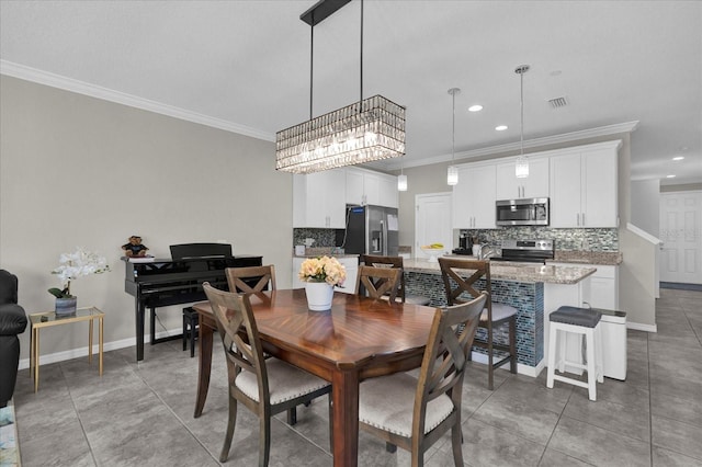 dining room with light tile patterned floors, visible vents, baseboards, and ornamental molding