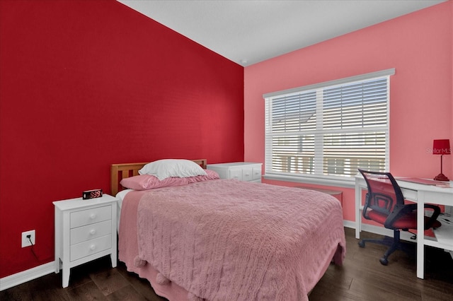 bedroom featuring baseboards and dark wood-style flooring