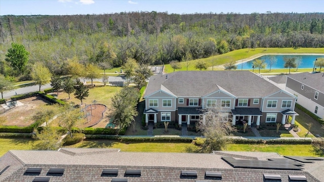 aerial view with a forest view and a water view