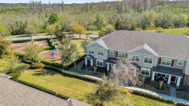 drone / aerial view with a wooded view