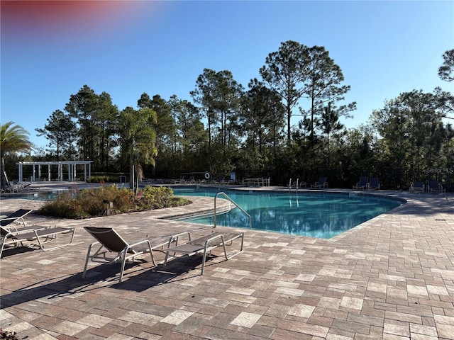 pool featuring a patio area and a pergola