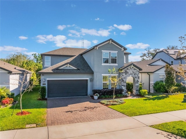 753 Daybreak Pl, Longwood, FL 32750 - view of front facade featuring a garage, stucco siding, decorative driveway, and a front yard