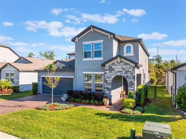 753 Daybreak Pl, Longwood, FL 32750 - traditional home featuring a front yard, driveway, stucco siding, stone siding, and a garage