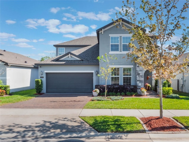753 Daybreak Pl, Longwood, FL 32750 - traditional-style house featuring stucco siding, driveway, roof with shingles, a front yard, and a garage