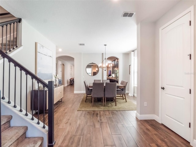 753 Daybreak Pl, Longwood, FL 32750 - interior space featuring wood finished floors, visible vents, arched walkways, stairs, and a chandelier