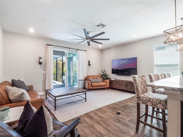 753 Daybreak Pl, Longwood, FL 32750 - living room featuring ceiling fan with notable chandelier, recessed lighting, wood finished floors, and visible vents