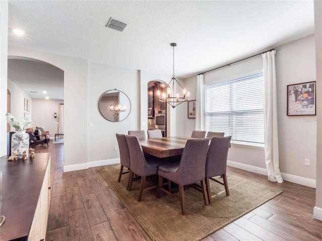 753 Daybreak Pl, Longwood, FL 32750 - dining space with wood finished floors, arched walkways, and a chandelier