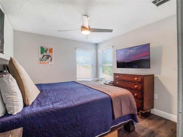 753 Daybreak Pl, Longwood, FL 32750 - bedroom featuring dark wood-style floors, visible vents, baseboards, ceiling fan, and a textured ceiling