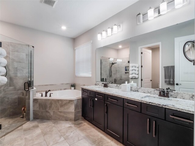 753 Daybreak Pl, Longwood, FL 32750 - full bathroom with visible vents, double vanity, a stall shower, a bath, and a sink