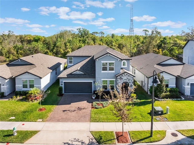 753 Daybreak Pl, Longwood, FL 32750 - traditional-style house with stucco siding, a front lawn, driveway, stone siding, and a forest view