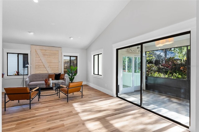 living area with light wood finished floors, recessed lighting, baseboards, and vaulted ceiling