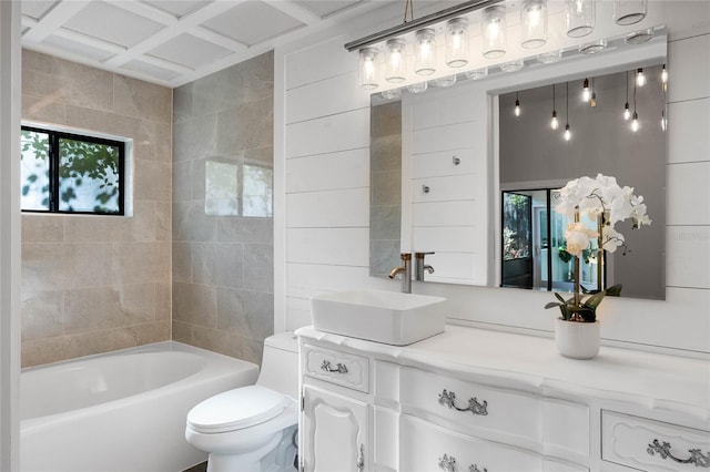 full bathroom with a bathtub, vanity, and toilet