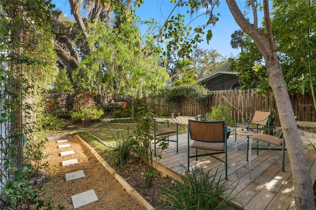 wooden deck with a fenced backyard