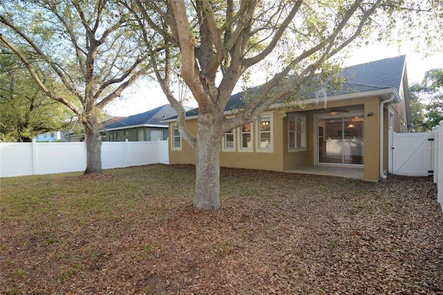 back of property featuring a patio area, a fenced backyard, and a gate