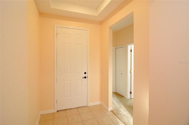 hallway featuring light tile patterned floors and baseboards