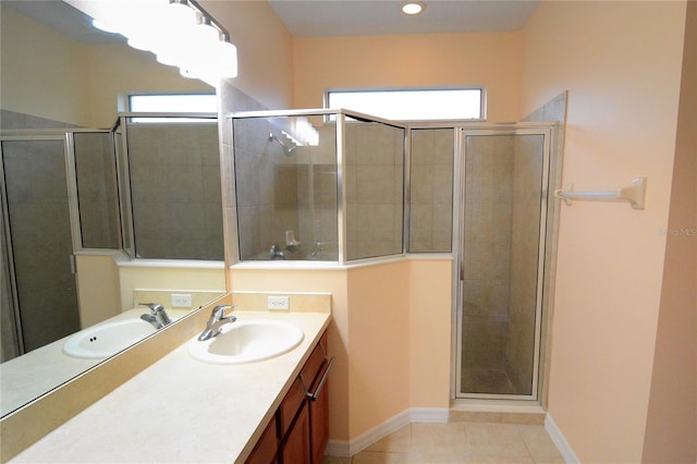 full bath with tile patterned flooring, a stall shower, vanity, and baseboards