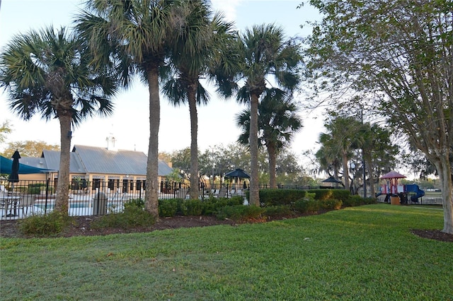 view of yard featuring fence and playground community