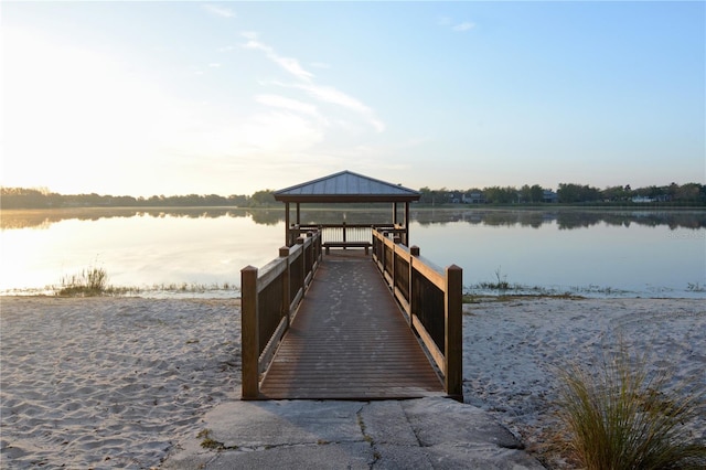 view of dock with a gazebo and a water view